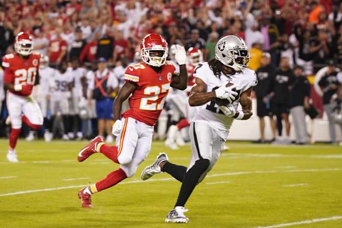 Las Vegas Raiders receiver Davante Adams (17) runs the ball in for a touchdown pursued by Kansas City Chiefs cornerback Rashad Fenton (27). Mandatory Credit: Jay Biggerstaff-USA TODAY Sports